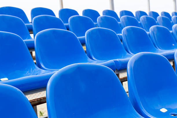istock Empty plastic blue chairs at stadium in a row. Closeup. 543660722