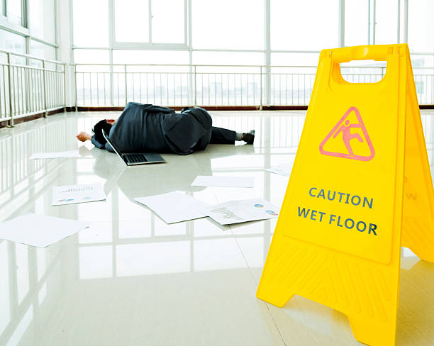 istock Businessman slipped on a floor next to caution sign 543661972