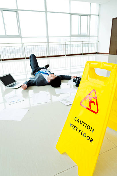 istock Businessman slipped on a floor next to caution sign 543662060