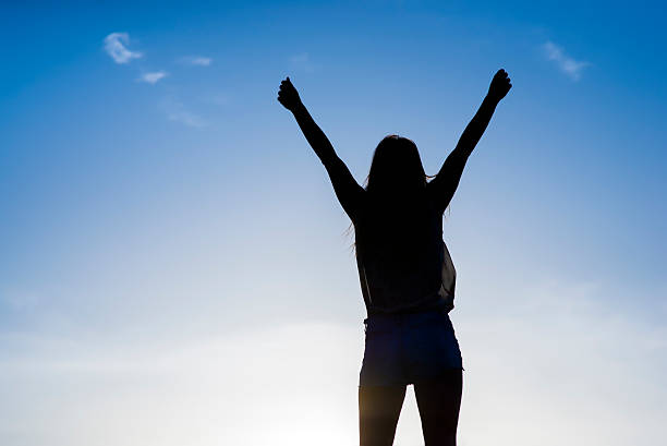 istock Girl Expressing Hope and Reaching For Heaven 543662480