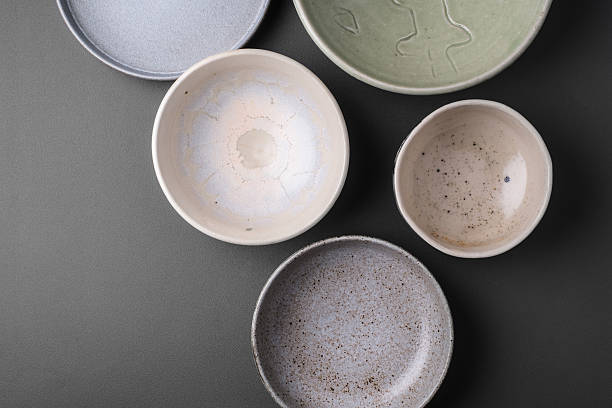 ceramic bowls on grey background ceramic bowls on grey background ceramics stock pictures, royalty-free photos & images