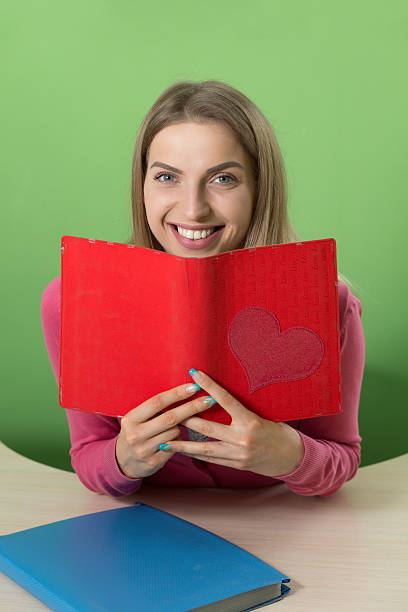 istock Lovely young teacher sitting at her desk and smiling 543663430