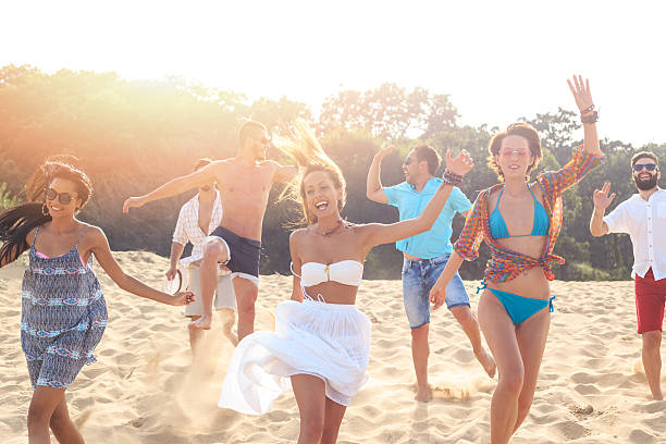 istock Group of happy friends dancing on the beach 543665508