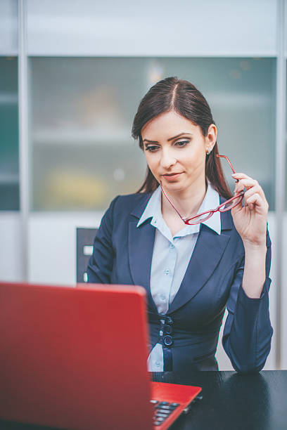 istock Young businesswoman using laptop in the office 543666176