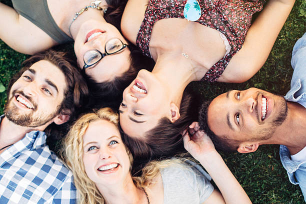 istock Friends Having Fun Laying in Grass 543666948