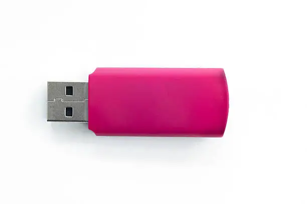 Photo of Pink usb pen drive on a white isolated background.