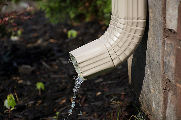 Gutter Downspout with water - side view stock photo