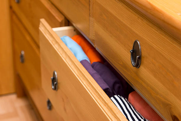 istock Folded clothes in chest of drawers closeup 543677654