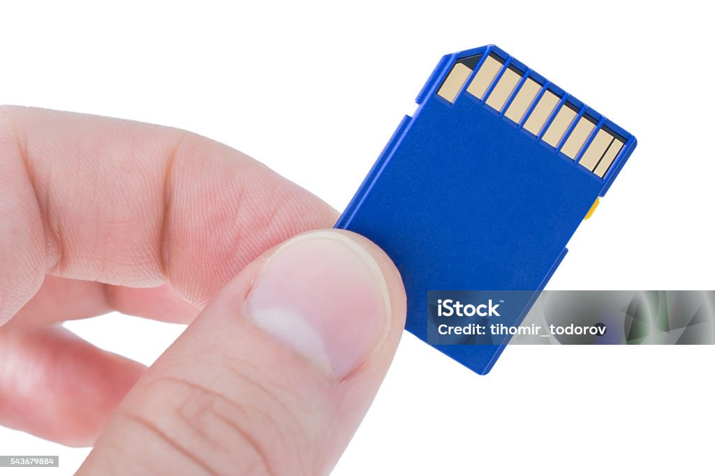 Holding a blue memory card Beautiful close up of holding a blue memory card on white background. Blue Stock Photo