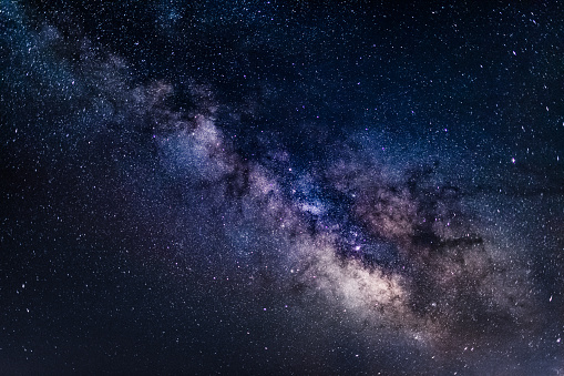 Beautiful view of the core of the Milky Way Galaxy in all its beauty as seen on a clear dark night during summer in Northern Hemisphere from Europe. Long exposure for 30 seconds, shot on Canon EOS full frame system with 35mm prime lens. Cold white balance applied to emphasise the space like feel. 