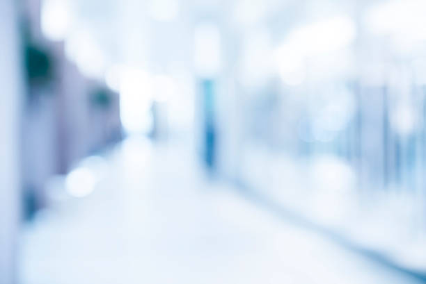 istock medical blurred background, empty hospital corridor in neon blue 543682404