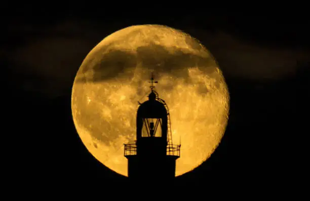lighthouse of illes medes in Costa Brava, Spain, in front of the full moon