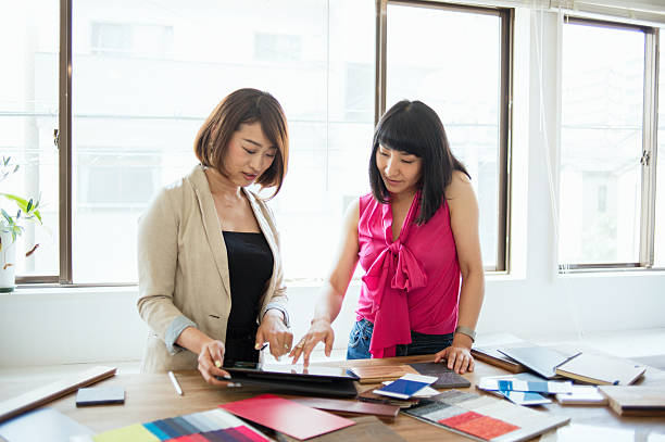 istock Team of Interior designers looking at a digital tablet 543688032