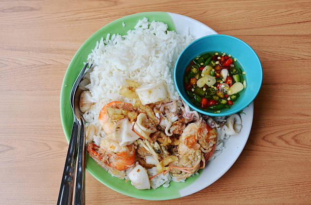 istock fried prawn and squid with garlic on rice 543688088