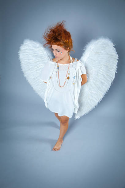 istock Red haired angel girl 543690192