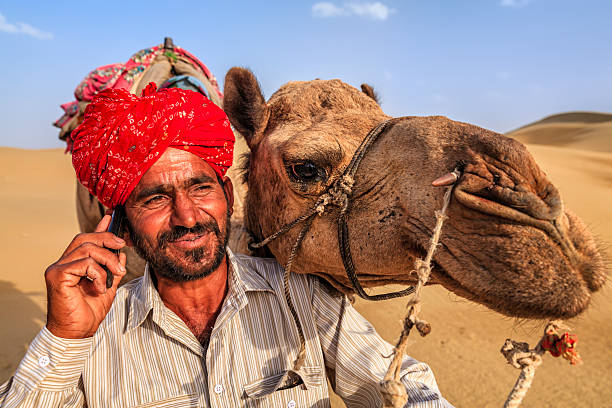 istock Indian man using a mobile, desert village, India 543690252