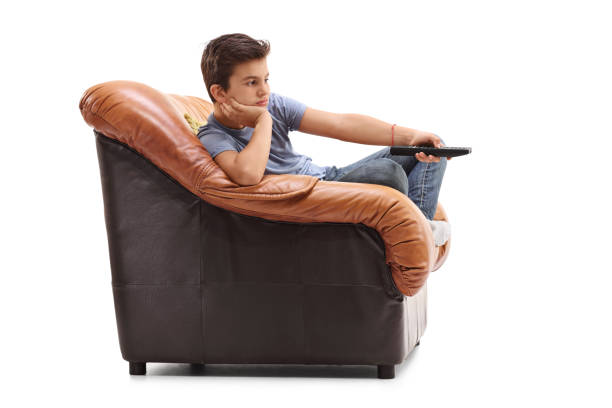 istock Bored kid changing channels on TV 543690354