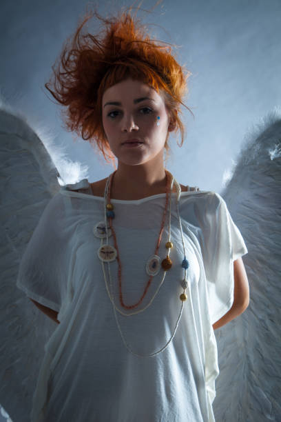 istock Red haired angel girl 543690440