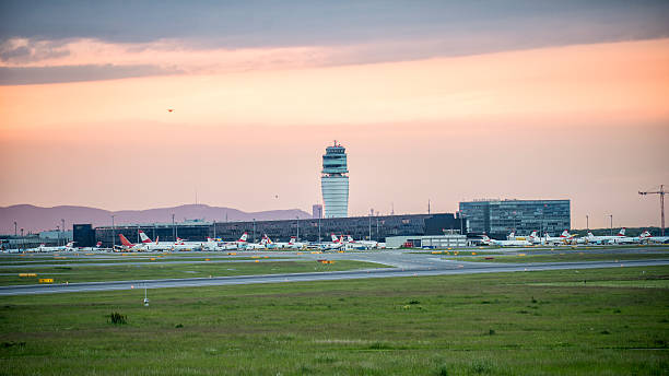 Air traffic control tower and jet aircraft approaching to land.