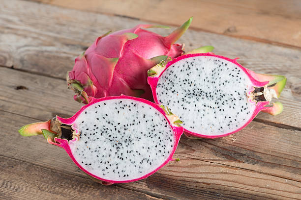 istock Half of Dragon fruit on wooden table. 543691754