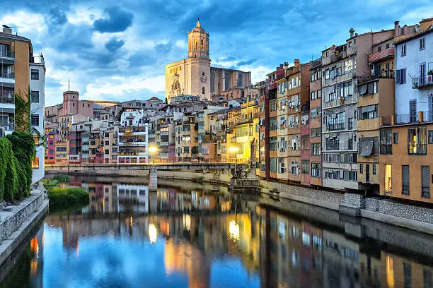 Cathedral and colorful houses on the side of river Onyar in the evening, Girona, Catalonia, Spain