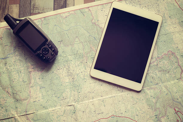 istock GPS navigator and tablet are on the paper map 543693904