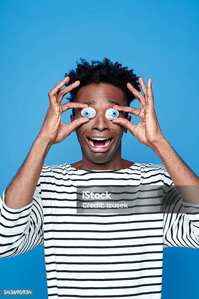 Afro American Young Man Wearing Funny Eyes Mask Stock Photo - Download Image Now - Men, African Ethnicity, African-American Ethnicity