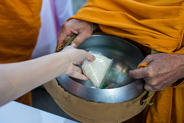 istock Hand put rice food offerings for monk 543697510