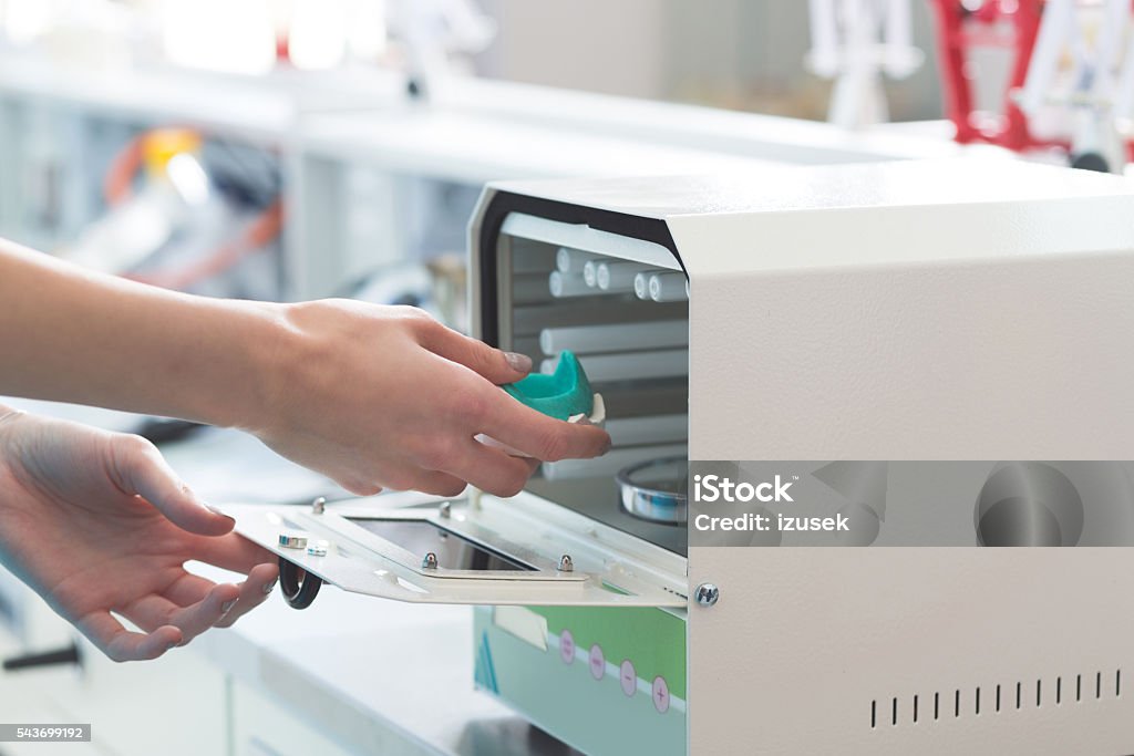 Prosthodontic lab Woman in a prosthodontic lab, learning prosthetic dentistry. Adult Stock Photo