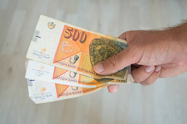 istock Man holding dinars 543803642
