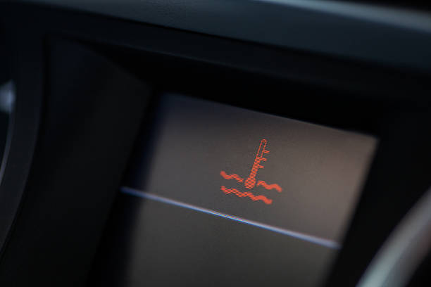 Car coolant warning Close up shot of a car's electronic dashboard, with coolant warning on. overheated photos stock pictures, royalty-free photos & images