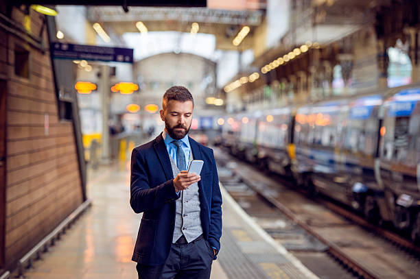 istock Hipster businessman with smartphone, waiting at the train platfo 543806042