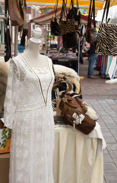 Lace dress and real fur and animal print handbags on street market in europe