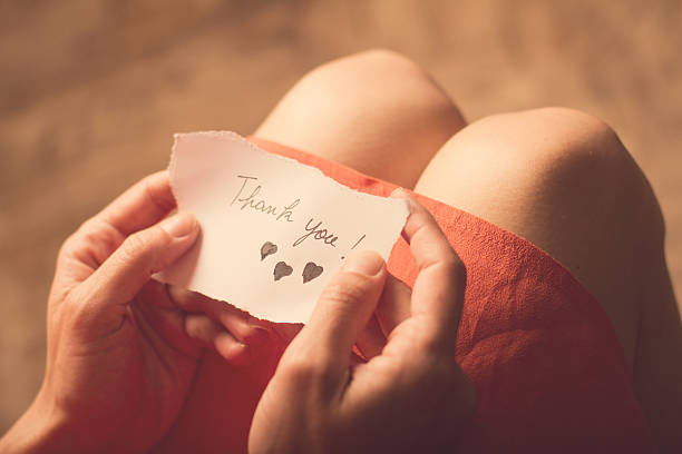 istock Woman holding a thank you note in her hand 543806538