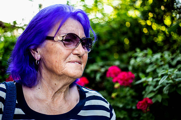 Senior woman portrait Senior woman portrait purple hair stock pictures, royalty-free photos & images