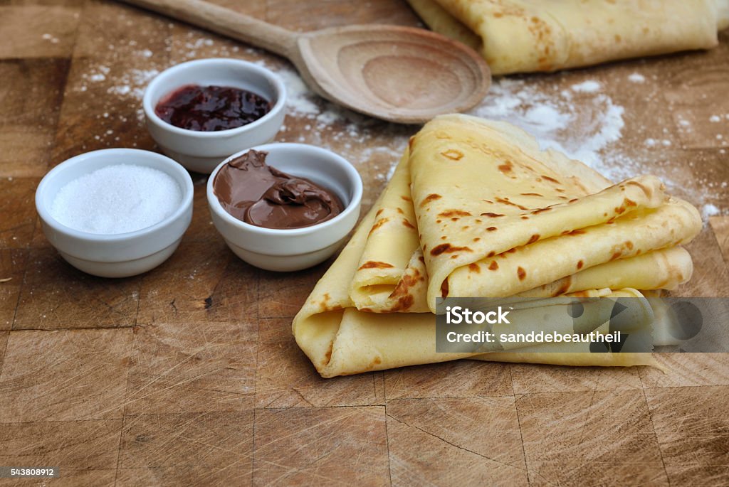 homemade french pancakes french homemade pancakes with accompaniments on wooden plank Crêpe - Pancake Stock Photo