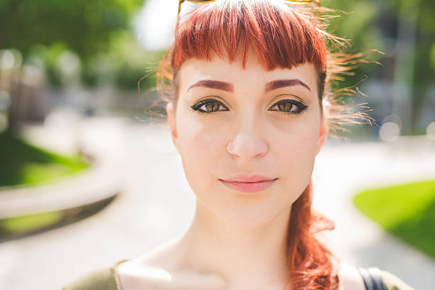 istock caucasian redhead woman looking in camera, serene 543810620