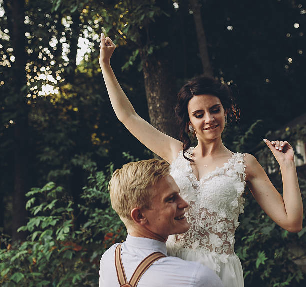 istock groom holds bride in his arms 543810958
