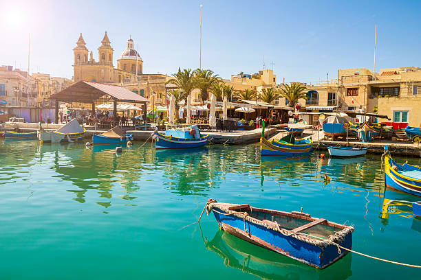 Malta - Marsaxlokk market with traditional colorful Luzzu fishing boats stock photo