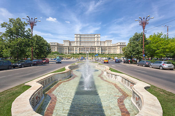 Palace of Parliament in daytime Daytime view of the Palace of the Parliament, the seat of the parliament of Romania, from Unirii Boulevard near Piata Constitutiei (Constitution Square). parliament palace in bucharest romania the largest building in europe stock pictures, royalty-free photos & images