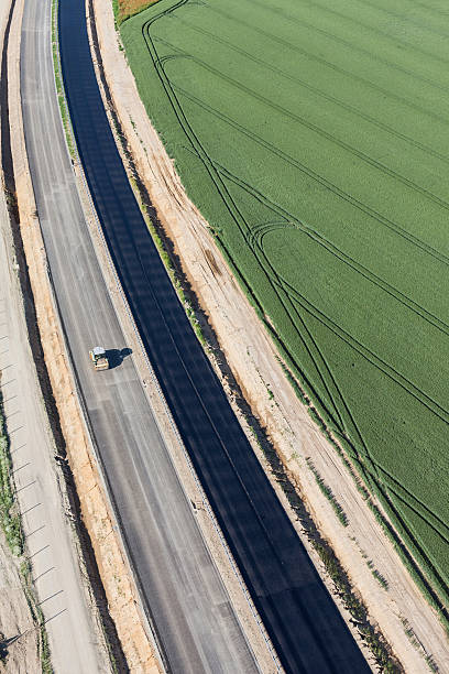 istock aerial view of the highway  and harvest fields 543816402