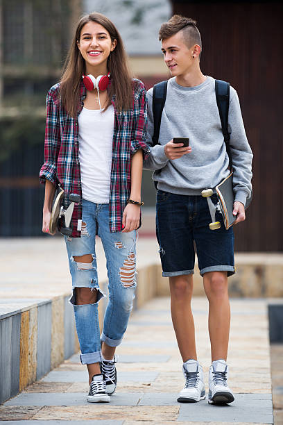 istock Teenagers with skateboards walking 543816502
