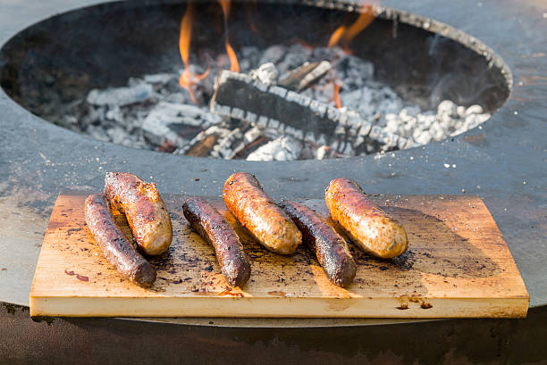 istock Grilling sausages on barbecue grill 543817270