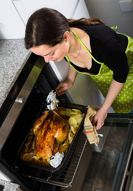 istock Woman cooking capon in baking tray 543817610