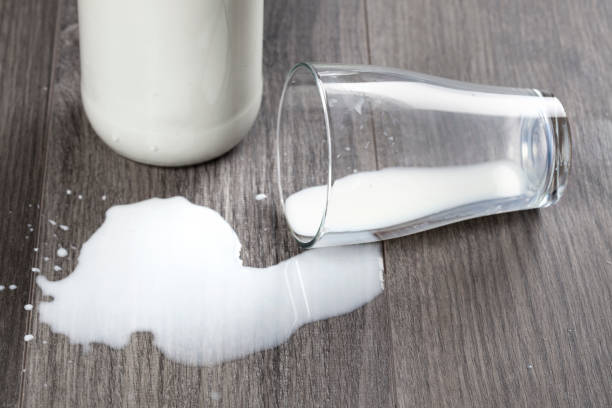 istock Spilled milk glass wooden table 543819012