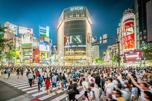 people walking across the Shibuya crossing in Tokyo, Japan