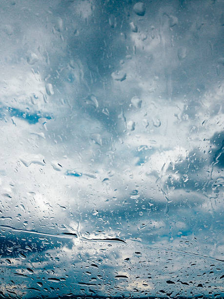 Background of rain drops on a window glass in a rainy day