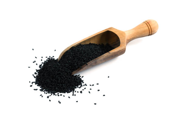 istock Nigella sativa, black cumin on spice shovel isolated on white. 543823696