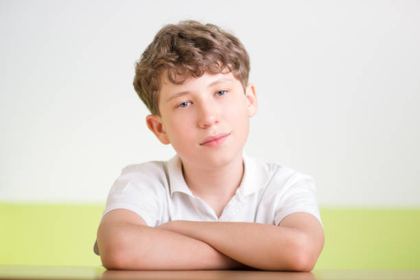 one  12 years old boy. Indoors photo. He is happy