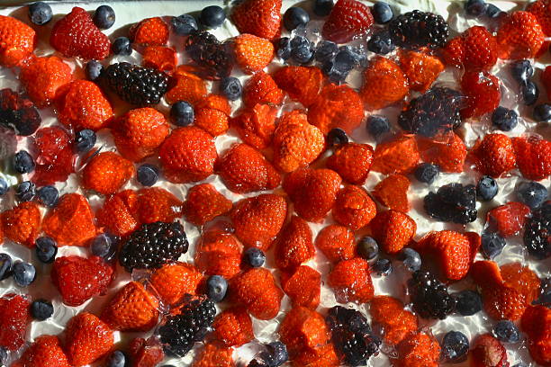 Strawberries, blueberries, blackberries and raspberries on cream, which mades isolated stock photo